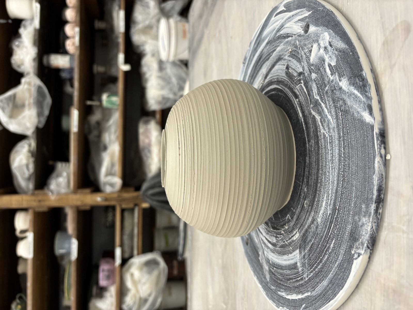 Bowl upside down on wheel bat, trimming