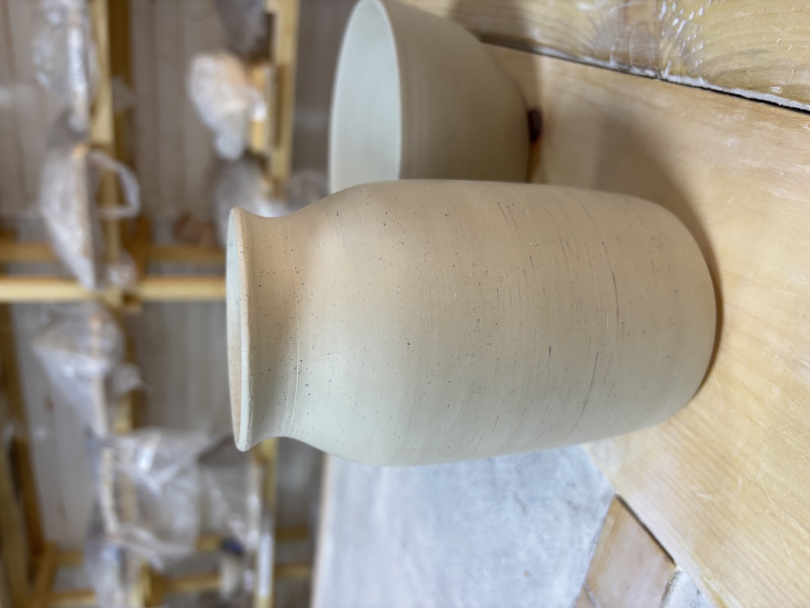 Vase with defined neck on studio shelf