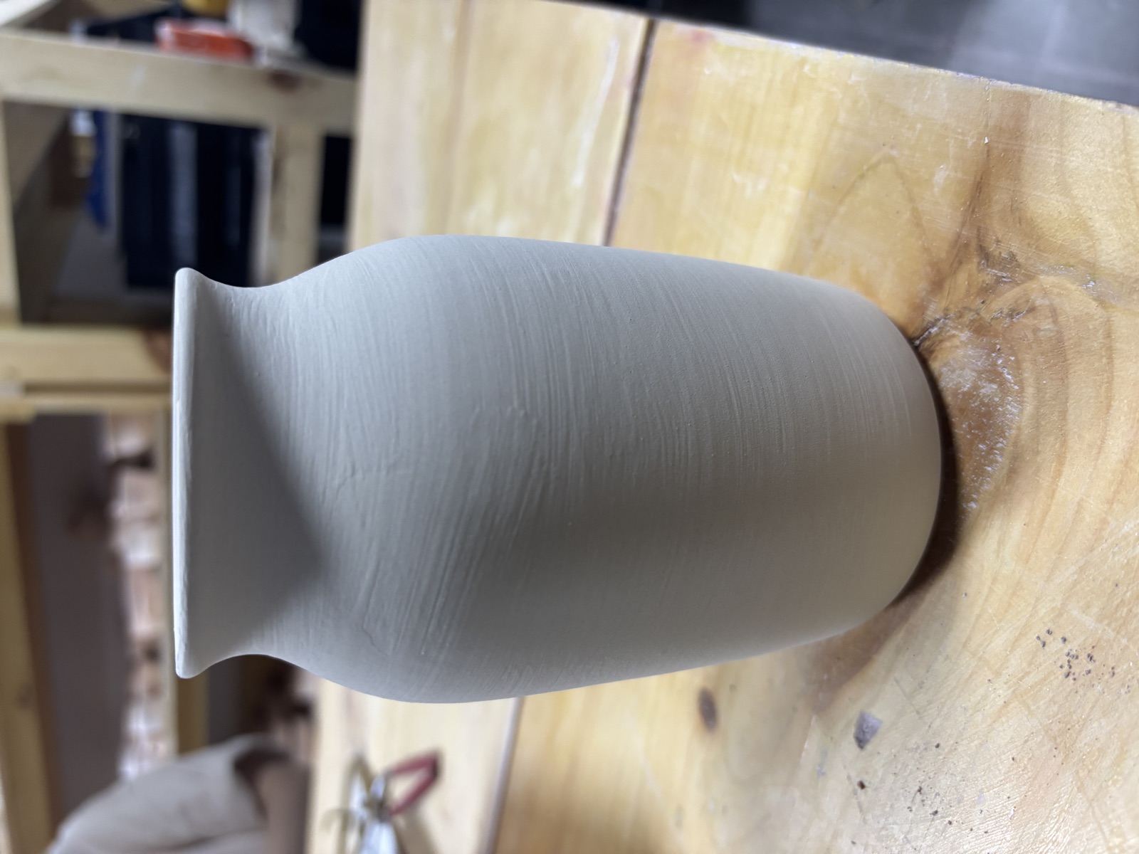 Simple vase form on wooden surface